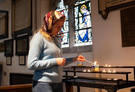 female lighting a candle